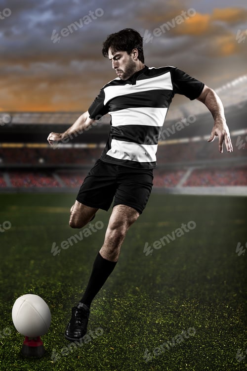 Preview: Rugby Player In A Black And White Uniform Kicking On A Stadium.