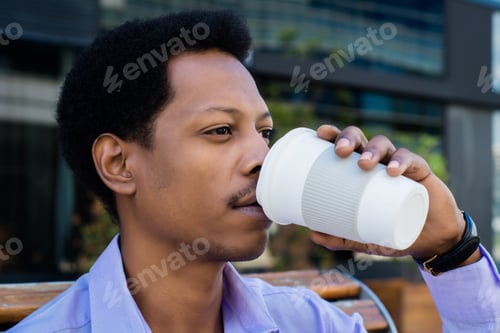 Preview: Portrait Of Young Latin Businessman Drinking Coffee Cup Outside Of Office.