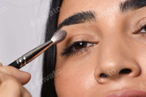 Preview: Young Beautiful Woman Applying Eyeshadow. Isolated White Background.