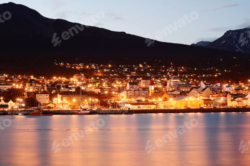 Preview: Cityscape With Mountains At The Night With Lights Reflected In River.