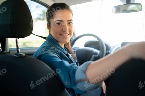 Preview: Woman Driving Her Car And Looking At Back Seat