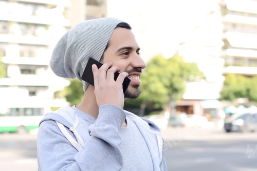 Preview: Portrait Of Young Latin Man Talking On The Phone. Outdoors.