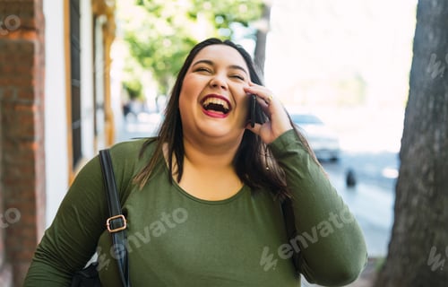 Preview: Young Plus Size Woman Talking On The Phone.