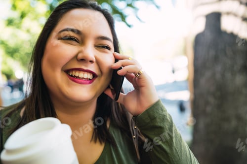 Preview: Young Plus Size Woman Talking On The Phone.