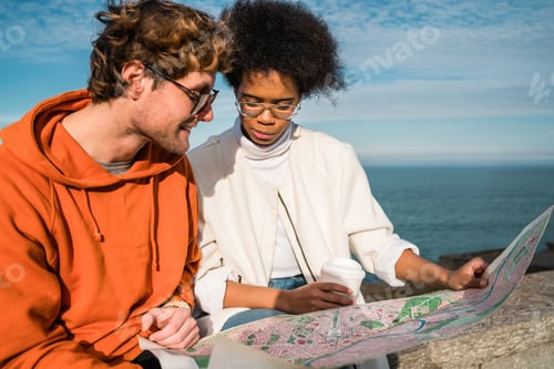 Preview: Portrait Of Two Young Friends Traveling Together, With A Map And Looking For Directions. Travel