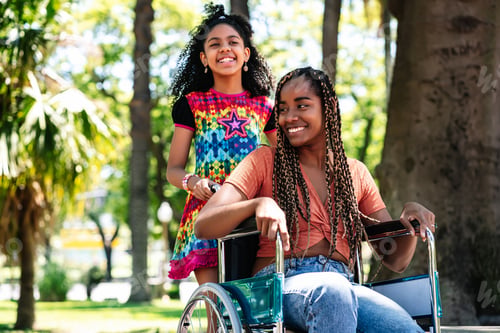 Preview: Woman In A Wheelchair At The Park With Her Daughter.