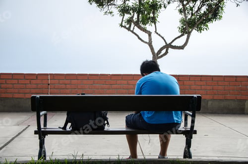 Preview: Child Sitting On His Back On A Bench In The Park