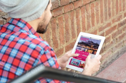 Preview: Young Latin Man With Tablet Booking A Hotel On Application. Travel And Media Concept. All Screen