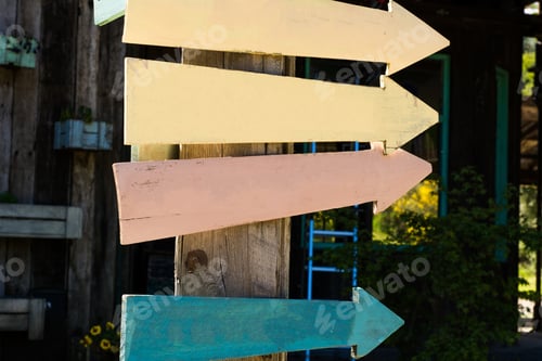Preview: Colorful And Empty Wooden Signpost Indicating Directions Outdoors.