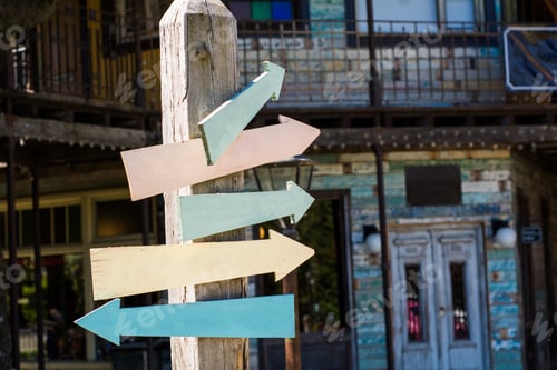 Preview: Colorful And Empty Wooden Signpost Indicating Directions Outdoors.