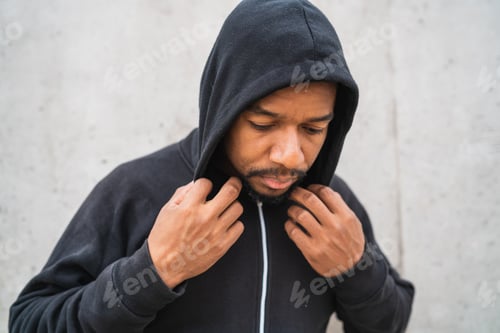 Preview: Portrait Of An Athletic Man Wearing Sport Clothes Against Grey Background. Sport And Healthy