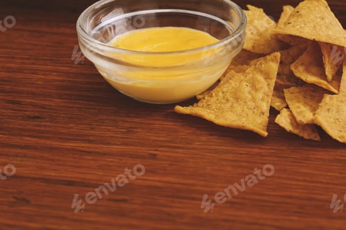 Preview: Close Up View Of Nachos With Cheese Dip. Unhealthy Food Concept