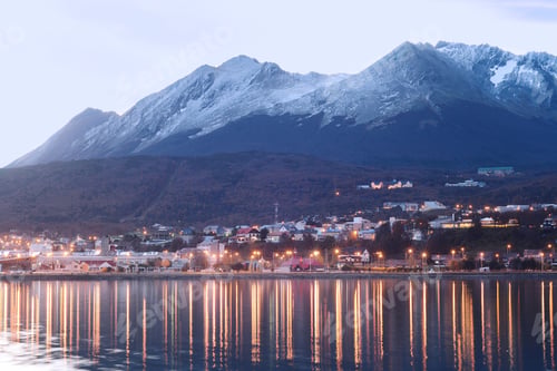 Preview: A Village On The River At The Sunset With Mountains At Back.