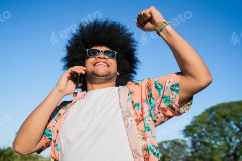 Preview: Latin Man Talking On The Phone Outdoors.