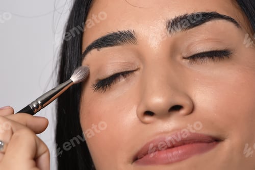 Preview: Young Beautiful Woman Applying Eyeshadow. Isolated White Background.