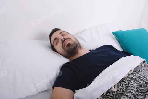 Preview: Close-Up Of Attractive Young Man Sleeping On Her Bed. Indoors.