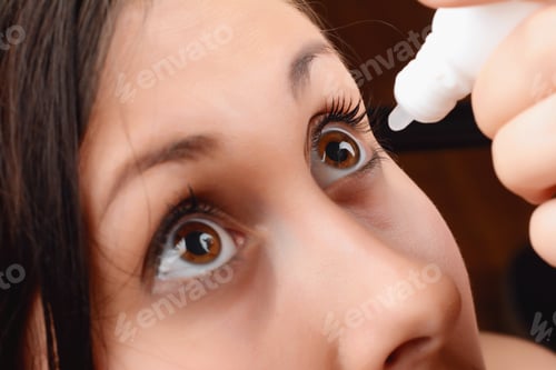 Preview: Closeup Of Female Face With Applying Contact Lens On Her Brown Eyes. Opthalmology Medicine Concept.