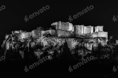 Preview: A Greyscale Of The Temple Of Olympian Zeus Under The Lights Surrounded By Trees During The Night
