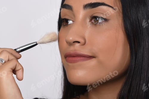 Preview: Young Beautiful Woman Applying Make Up. Isolated White Background.