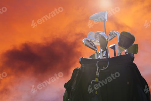 Preview: Close Up Of A Golf Bag With Clubs Against A Sunset Sky
