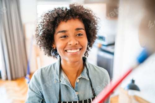 Preview: Portrait Of Young Afro Woman Cleaning Her New House With A Duster. Housekeeping And Cleaning