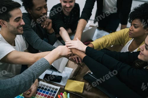 Preview: Team Of Work Of Creative Designers Showing Unity With Their Hand Together During Meeting. Business