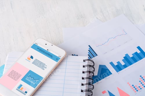 Preview: Close Up Of Spiral Notepad, Financial Papers And Smartphone With Statistics, Charts And Graphic