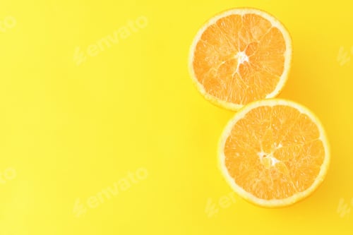 Preview: Close Up Of Orange Slices On Yellow Background. Heatly Food Concept