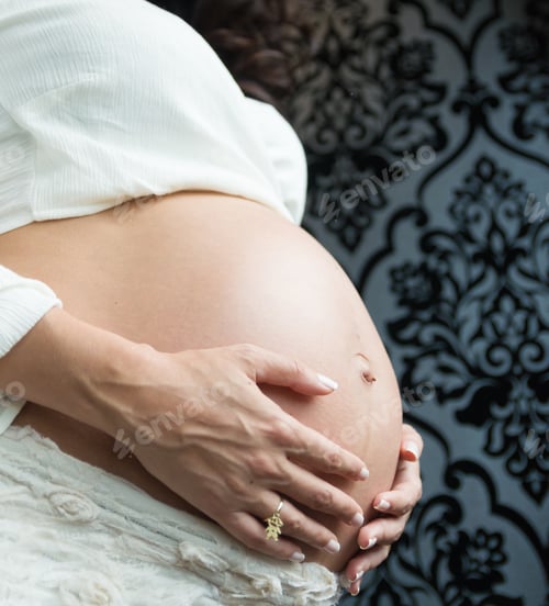 Preview: Pregnancy, Rest, People And Expectation Concept - Happy Pregnant Woman Sitting On Bed And Touching