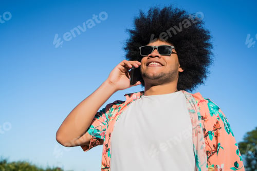 Preview: Latin Man Talking On The Phone Outdoors.