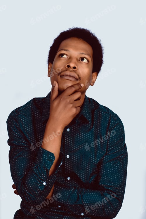 Preview: Portrait Of Afro American Thinking Man With Hand Near Face On Studio.