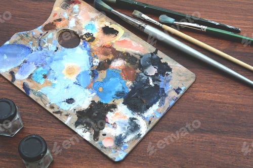 Preview: Artist'S Palette With Colorful Oil Paint Strokes And Paintbrushes On Wooden Background. Art Concept
