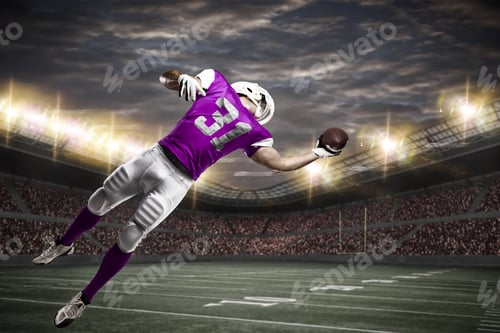 Preview: Football Player With A Pink Uniform Catching A Ball On A Stadium.