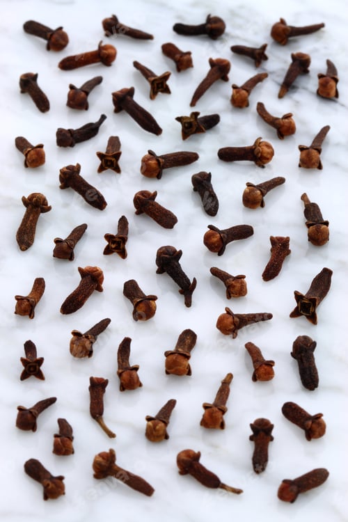 Preview: Beautiful Cloves, Aromatic Flower-Buds, On Carrara Marble Countertop.