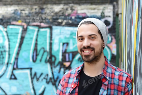 Preview: Portrait Of A Young Latin Man Against Colorful Wall. Outdoors. Urban Concept.