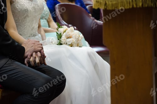 Preview: Bride And Groom Holding Hands And The Bride With A Bouquet Of Roses