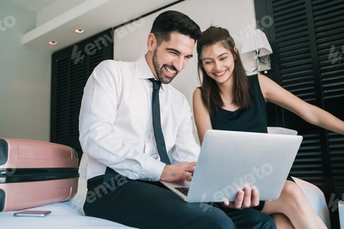 Preview: Portrait Of Two Young Business People Working Together On The Laptop At The Hotel Room. Business