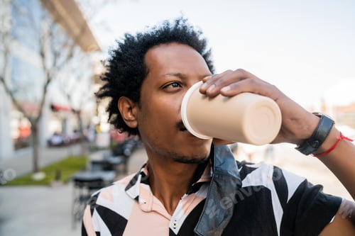 Preview: Afro Man Drinking A Cup Of Coffee Outdoors.