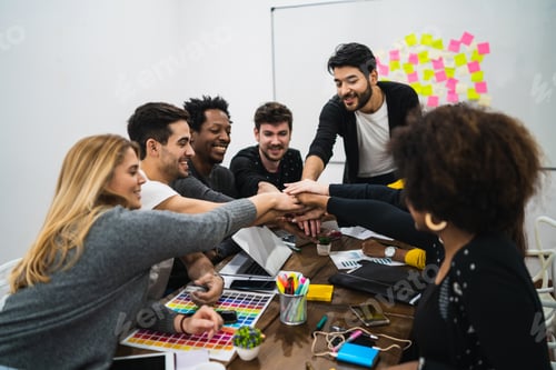 Preview: Team Of Work Of Creative Designers Showing Unity With Their Hand Together During Meeting. Business