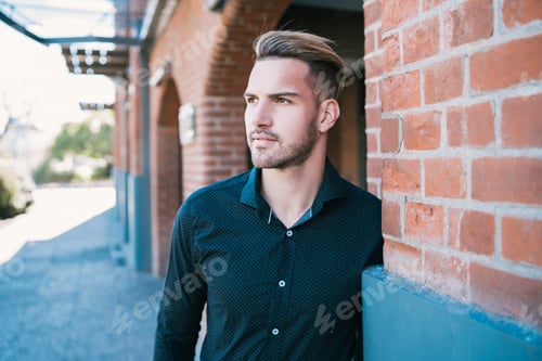 Preview: Portrait Of Attractive Young Man Wearing Casual Clothes, Standing Outdoors With Urban Background.
