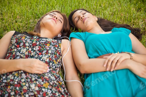Preview: Cute Female Best Friends Relaxing And Listening To Music At A Park