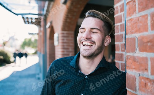 Preview: Portrait Of Young Handsome Man Laughing And Walking On The Street. Urban Concept.