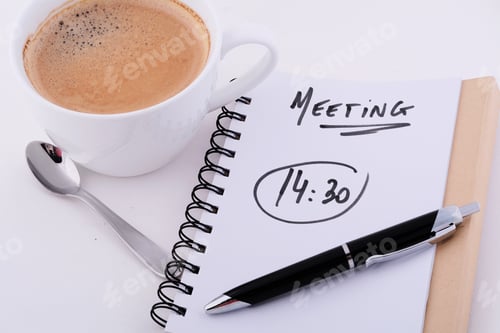 Preview: Notepad With Text "Meeting 14:30" With Cup Of Coffee. Business Concept