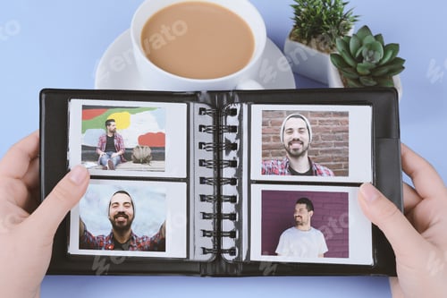 Preview: Photo Album With Instant Photos Of Young Latin Man On Light Blue Background. Memories Concept