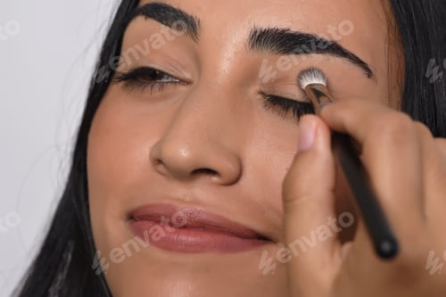 Preview: Young Beautiful Woman Applying Eyeshadow. Isolated White Background.