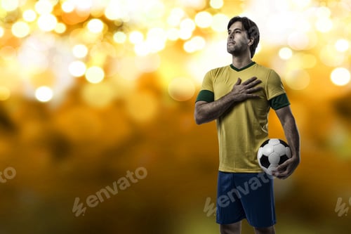 Preview: Brazilian Soccer Player, Celebrating On A Yellow Lights Background.
