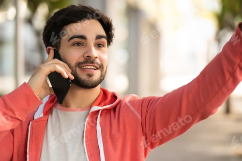 Preview: Young Man Talking On The Phone Outdoors.