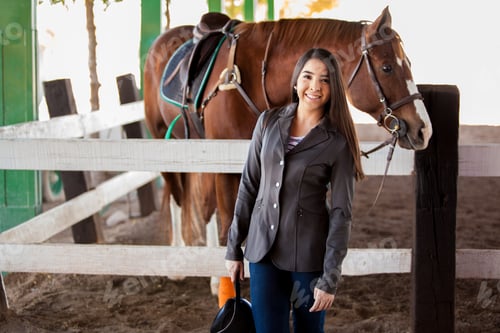 Preview: Beautiful Female Rider Standing Next To Her Horse At The Track And Smiling