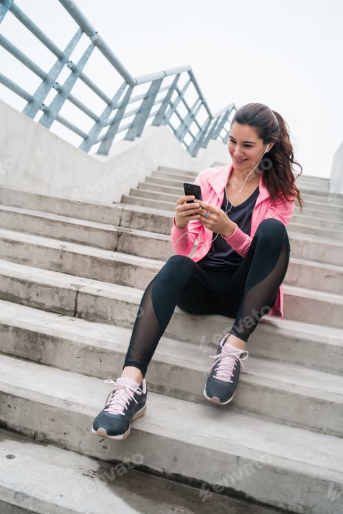 Preview: Portrait Of An Athletic Woman Using Her Mobile Phone On A Break From Training. Sport And Health