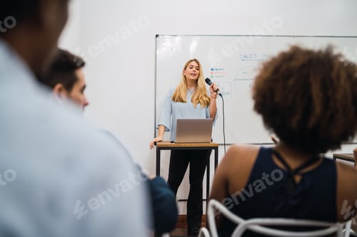 Preview: Friendly Business Woman Explaining Plan Of Work And Answering Questions On A Work Conference